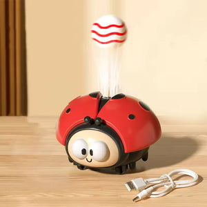 Red ladybug-shaped humidifier with a white cord on a wooden surface
