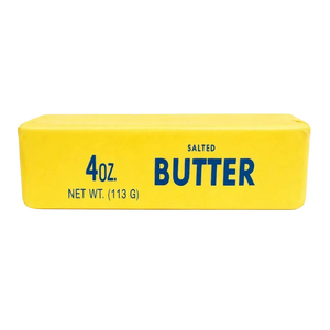 Giant butter stick squishy, 24 cm long, held in two hands with a thumbprint dent slowly rising back out