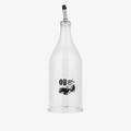 Clear glass oil bottle with black label on a white background