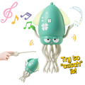 Toy squid with musical notes and a hand holding a wand on a white background