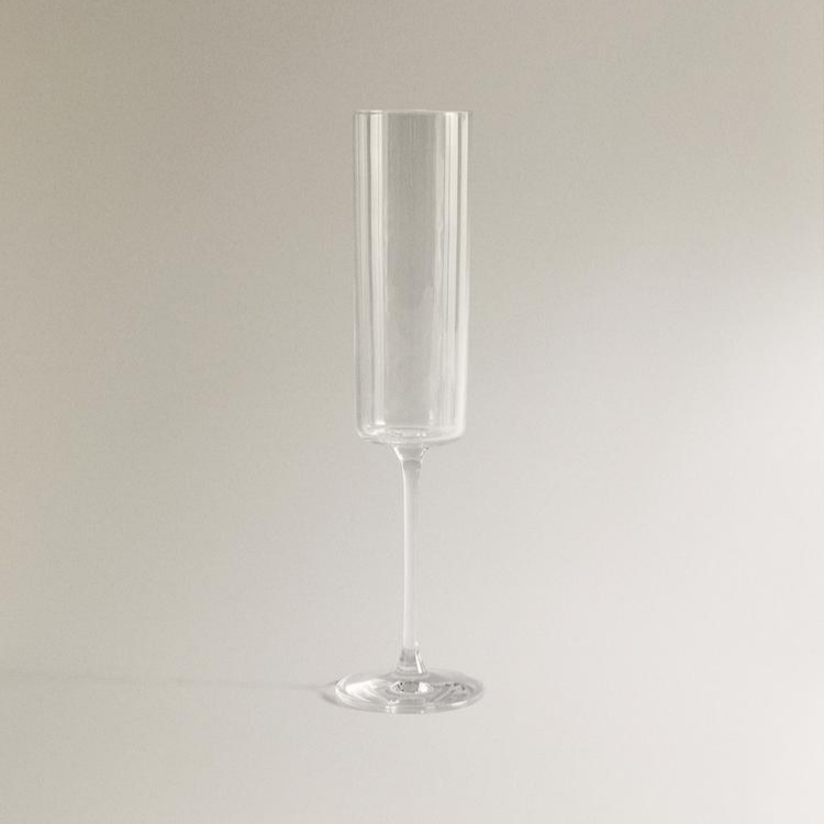 Close-up of champagne bubbles in a sleek crystal flute.