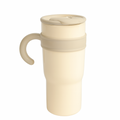 Beige ceramic mug with a handle on a white background