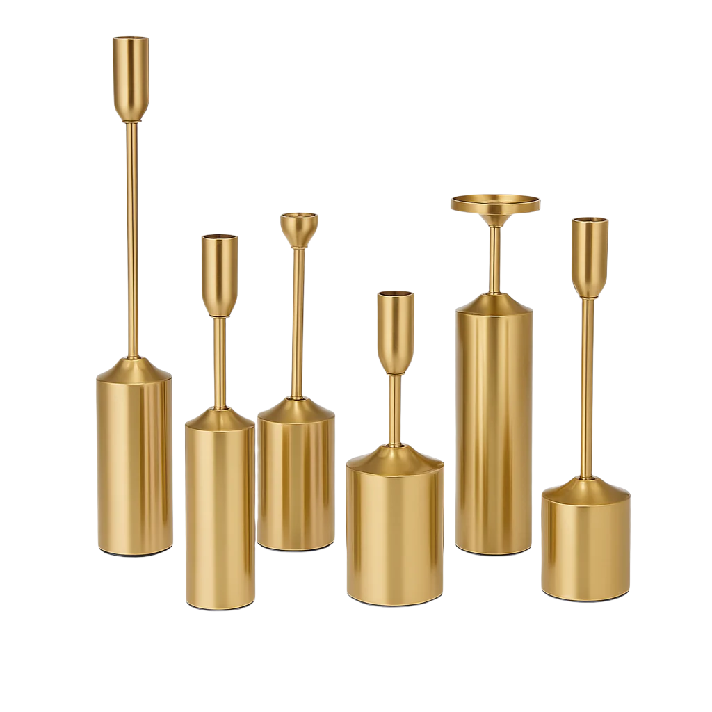 Set of gold candle holders of various shapes and sizes on a white background