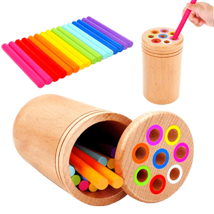 Colorful wooden sticks with a wooden container on a white background