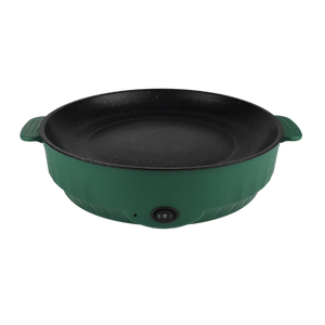 Electric frying pan sizzling with vegetables on a kitchen counter.
