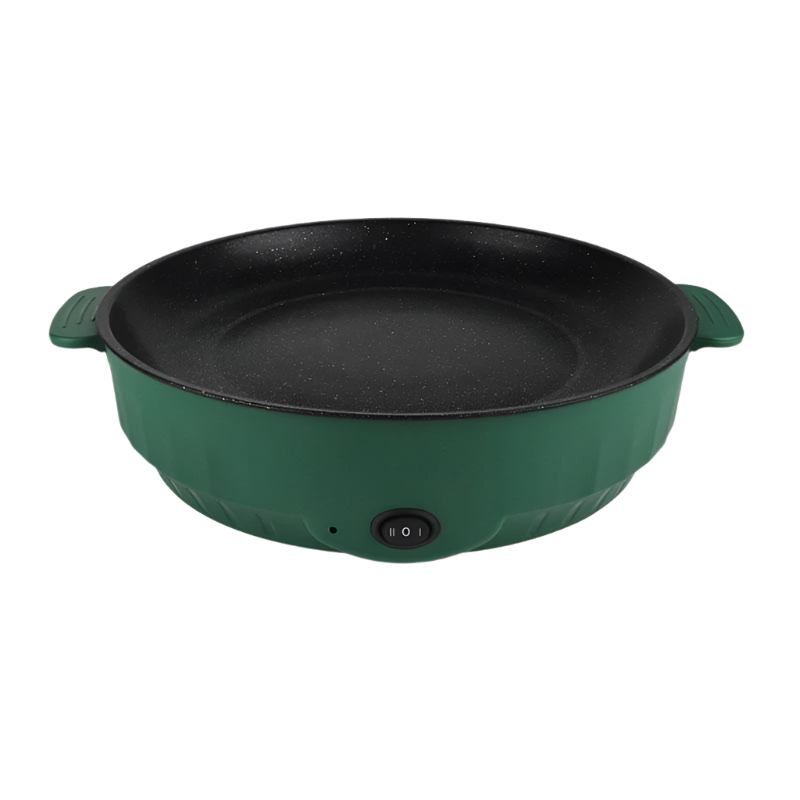 Electric frying pan sizzling with vegetables on a kitchen counter.