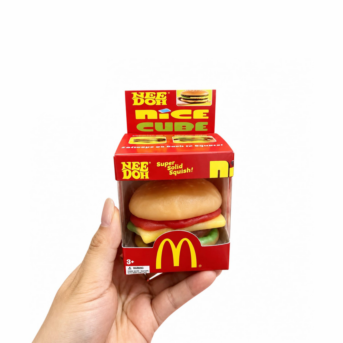 Squishy burger fidget toy pulled apart into five soft layers — bun, tomato, cheese, patty and lettuce