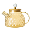Glass teapot with gold accents on a white background