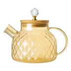Glass teapot with gold accents on a white background