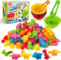 Colorful dinosaur toys with a toy kitchen set and packaging on a white background