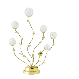Decorative lamp with gold branches and white spherical elements on a white background
