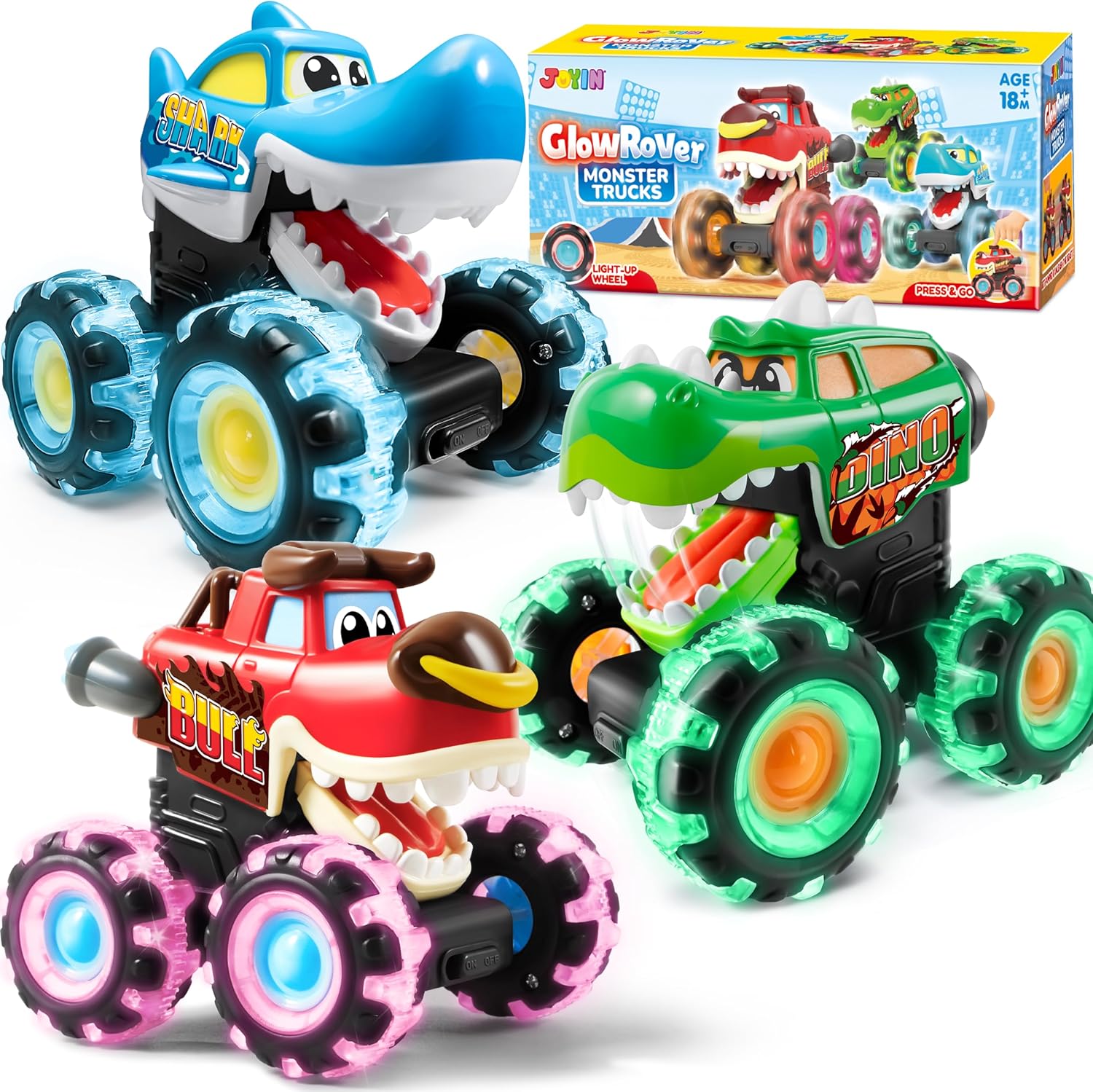 Toy monster trucks with colorful designs and a box in the background