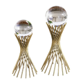 Two gold twisted rod sculptures topped with clear spheres, serving as modern decorative accents for home or office.







