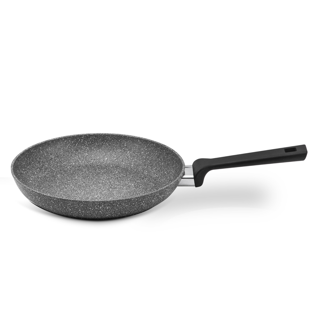 Eco-friendly Planeta frying pan with recycled aluminum sizzling veggies on induction hob.