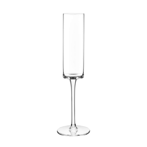 Sleek outdoor champagne flutes on a picnic table with sunset backdrop.