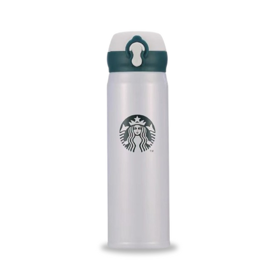 White Starbucks coffee bottle on a modern café table.