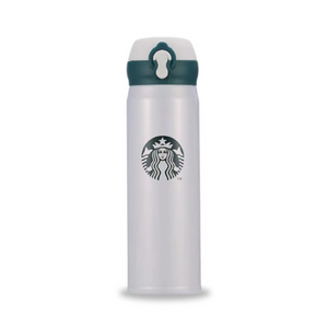 White Starbucks coffee bottle on a modern café table.