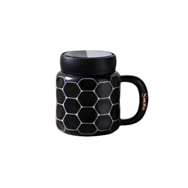 Black ceramic mug with smile design on a cozy kitchen counter.