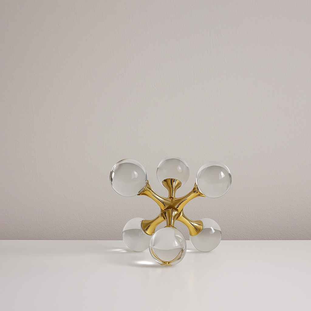 Transparent crystal ball molecular structure model with alloy connectors, placed as a modern desktop or shelf decoration.

