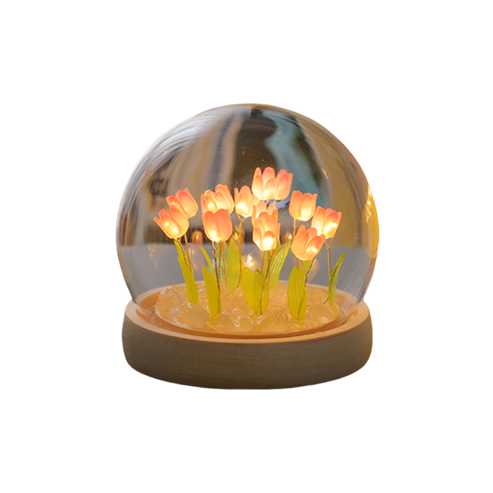 Decorative lamp with glowing flowers inside a transparent dome on a white background