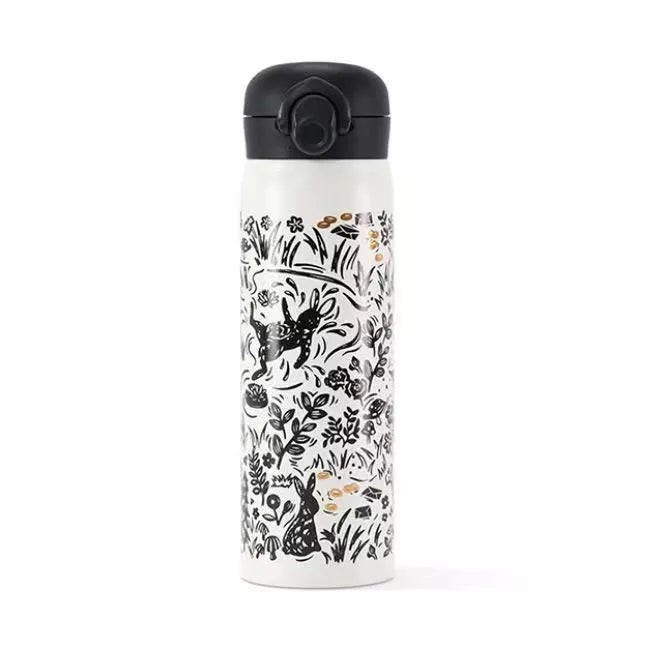 Starbucks Graffiti Rabbit Thermos on a café table.